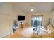 Living room with hardwood floors, large TV and access to a balcony at 2025 E Campbell Ave # 330, Phoenix, AZ 85016