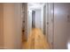 Light-filled hallway with light wood flooring and doors at 2025 E Campbell Ave # 330, Phoenix, AZ 85016