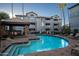 Community pool with lounge chairs and a covered patio at 2025 E Campbell Ave # 330, Phoenix, AZ 85016