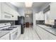 Bright kitchen with white cabinets, black appliances, and tile flooring at 8333 W Wescott Dr, Peoria, AZ 85382