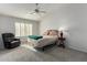Spacious bedroom with a comfortable bed and relaxing armchair at 8333 W Wescott Dr, Peoria, AZ 85382