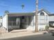White manufactured home with carport and desert landscaping at 225 S Motherlode Dr, Apache Junction, AZ 85119