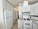 White appliances and gray cabinets in this galley kitchen at 225 S Motherlode Dr, Apache Junction, AZ 85119