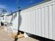 Exterior view of a manufactured home with steps and a storage area at 225 S Motherlode Dr, Apache Junction, AZ 85119