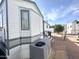 Exterior view of the home with AC unit and landscaping at 225 S Motherlode Dr, Apache Junction, AZ 85119