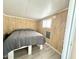 Simple bedroom with wood paneling and grey bedding at 225 S Motherlode Dr, Apache Junction, AZ 85119