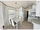 Kitchen with white table and chairs, and white appliances at 225 S Motherlode Dr, Apache Junction, AZ 85119