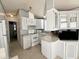 Kitchen boasts white cabinets, an island, and modern appliances at 225 S Motherlode Dr, Apache Junction, AZ 85119
