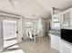 Bright kitchen features white cabinetry, and a dining area at 225 S Motherlode Dr, Apache Junction, AZ 85119