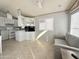 Open living room and kitchen with modern gray sofa at 225 S Motherlode Dr, Apache Junction, AZ 85119