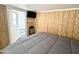 Bedroom with wood paneling and access to exterior at 225 S Motherlode Dr, Apache Junction, AZ 85119