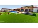 Spacious backyard oasis with a refreshing pool and artificial turf at 5604 S 225Th Ave, Buckeye, AZ 85326