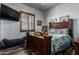 Bedroom with wood bed frame and plenty of natural light at 5604 S 225Th Ave, Buckeye, AZ 85326