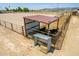 Cattle enclosure with covered shelter and feeding trough at 5604 S 225Th Ave, Buckeye, AZ 85326