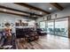 Open living area with wood beams, leather sofas, and a view to the kitchen and backyard at 5604 S 225Th Ave, Buckeye, AZ 85326