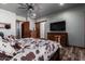 Bright bedroom with a large TV and wooden dresser at 5604 S 225Th Ave, Buckeye, AZ 85326