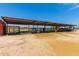Covered stalls for animals, with fencing and water troughs at 5604 S 225Th Ave, Buckeye, AZ 85326