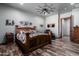 Spacious bedroom with wooden furniture and large ceiling fan at 5604 S 225Th Ave, Buckeye, AZ 85326