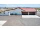 Home's exterior showcases a three-car garage and AC units at 5604 S 225Th Ave, Buckeye, AZ 85326