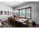 Farmhouse-style dining room with large window and wooden table at 5604 S 225Th Ave, Buckeye, AZ 85326