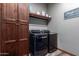 Laundry room with washer, dryer, and ample cabinet storage at 5604 S 225Th Ave, Buckeye, AZ 85326