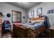 Bedroom with wooden bed frame and ceiling fan at 5604 S 225Th Ave, Buckeye, AZ 85326