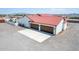 Two-car garage with attached home, gravel driveway, and landscaping at 5604 S 225Th Ave, Buckeye, AZ 85326