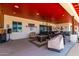Covered patio with seating area, fire pit and ceiling fan at 5604 S 225Th Ave, Buckeye, AZ 85326