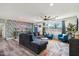 L-shaped sectional sofa, accent chairs, and tropical wall art at 8344 E Bonnie Rose Ave, Scottsdale, AZ 85250