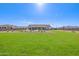 Large backyard with grassy area, sparkling pool, and modern home at 25219 S 194Th St, Queen Creek, AZ 85142