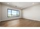Light-filled bedroom with hardwood floors and a large window at 25219 S 194Th St, Queen Creek, AZ 85142