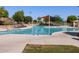 Community pool with lounge chairs and shade structures at 2664 E San Miguel Dr, Casa Grande, AZ 85194