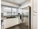 Modern kitchen with white cabinets, stainless steel appliances and granite countertops at 19820 N 13Th Ave # 277, Phoenix, AZ 85027