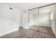 A bedroom with mirrored closet doors and wood-look laminate floors at 1315 E Gemini Dr, Tempe, AZ 85283