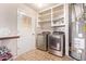 Laundry room with washer, dryer, and shelving at 10448 W Caron Dr, Sun City, AZ 85351