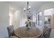 Bright dining area with a rustic table, gray chairs, and kitchen view at 4662 W Ivanhoe St, Chandler, AZ 85226