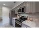 Modern kitchen with gray cabinets, stainless steel appliances, and marble countertops at 4662 W Ivanhoe St, Chandler, AZ 85226