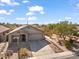 Single-story home with desert landscaping, driveway, and a two-car garage at 4657 E Matt Dillon Trl, Cave Creek, AZ 85331