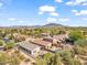 Aerial view of a single-story house with a pool and mountain views in the background at 4657 E Matt Dillon Trl, Cave Creek, AZ 85331