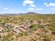 Aerial view of homes with desert landscape and mountain backdrop at 4657 E Matt Dillon Trl, Cave Creek, AZ 85331