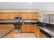 Modern kitchen with dark countertops and wood cabinets at 4657 E Matt Dillon Trl, Cave Creek, AZ 85331