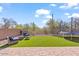 Landscaped backyard oasis with artificial turf, seating area, and trampoline at 4657 E Matt Dillon Trl, Cave Creek, AZ 85331