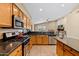 Bright kitchen featuring stainless steel appliances and dark countertops at 4657 E Matt Dillon Trl, Cave Creek, AZ 85331