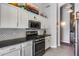 Modern kitchen with white cabinets, stainless steel appliances, and stylish backsplash at 3055 N Red Mtn # 122, Mesa, AZ 85207