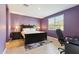 Main bedroom with purple walls and workspace at 24884 N 171St Ln, Surprise, AZ 85387