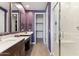 Bathroom with double vanity, large mirrors and walk-in shower at 24884 N 171St Ln, Surprise, AZ 85387