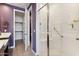Walk-in shower with bench seat in a bathroom with purple walls at 24884 N 171St Ln, Surprise, AZ 85387