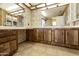 Double vanity bathroom with wood cabinets and floral wallpaper at 11275 N 99Th Ave # 145, Peoria, AZ 85345