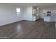 Spacious living room with wood-look tile flooring and kitchen views at 48466 N Duran Way, Gold Canyon, AZ 85118