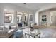 Light and airy living room with a glass-top coffee table and French doors leading to the backyard at 2340 W Horsetail Trl, Phoenix, AZ 85085